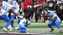 Detroit Lions safety Morice Norris  is hit in the helmet by Atlanta Falcons running back Nathan Carter (38) during the second half of an NFL preseason football game Friday.
