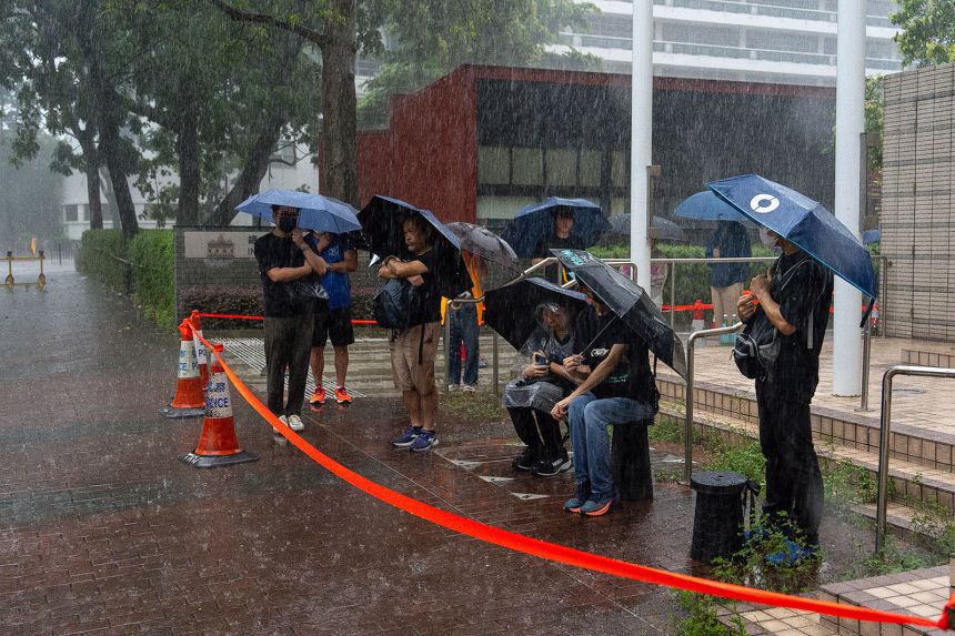 People wait to enter the West Kowloon Magistrates' Courts ahead of the closing statements for Hong Kong activist publisher Jimmy Lai's national security trial in Hong Kong on Thursday.