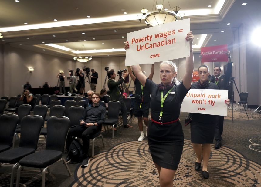 Air Canada executives are interrupted by Air Canada flight attendants during a news conference as a possible strike looms, in Toronto on August 14, 2025.