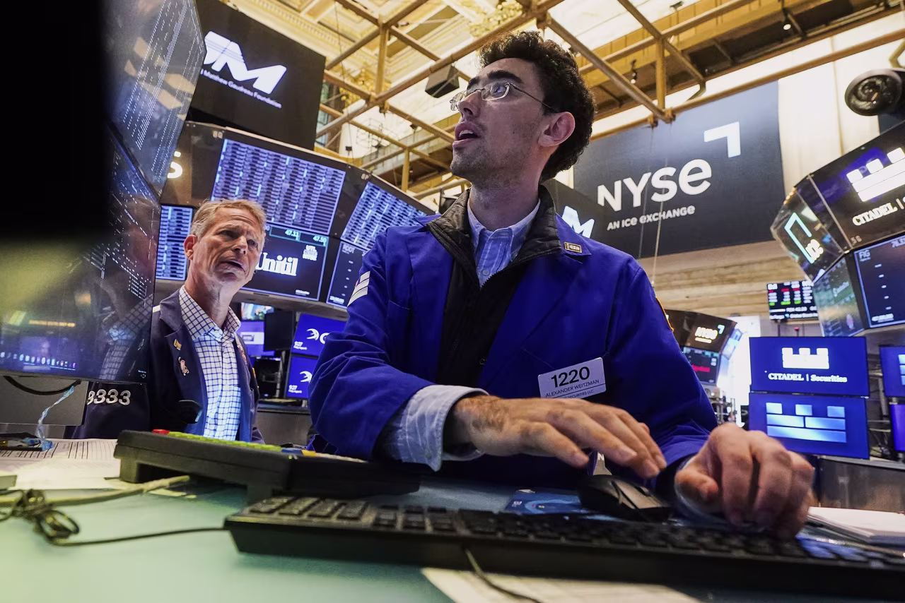Traders work on the floor of the New York Stock Exchange on August 15.