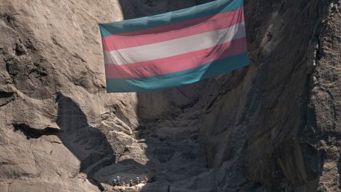 A group of people, including Shannon Joslin, a Yosemite National Park ranger and biologist who was fired, hang a transgender flag on El Capitan in Yosemite National Park, California on May 20, 2025.