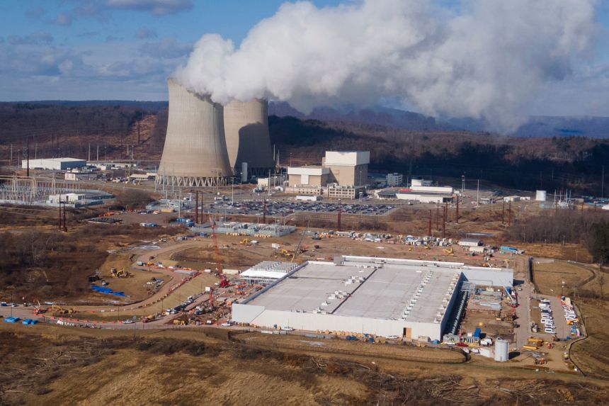 A data center owned by Amazon Web Services, front right, is under construction next to the Susquehanna nuclear power plant in Berwick, Pennsylvania, on January 14.
