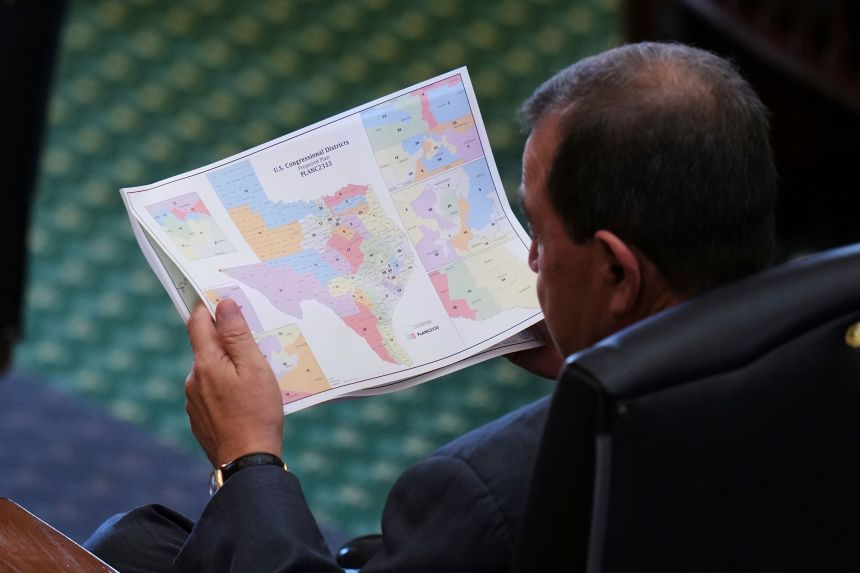 Texas state Sen. Pete Flores looks over a redrawn US congressional map during debate over a bill in the Senate Chamber of the Texas Capitol in Austin, on August 22.