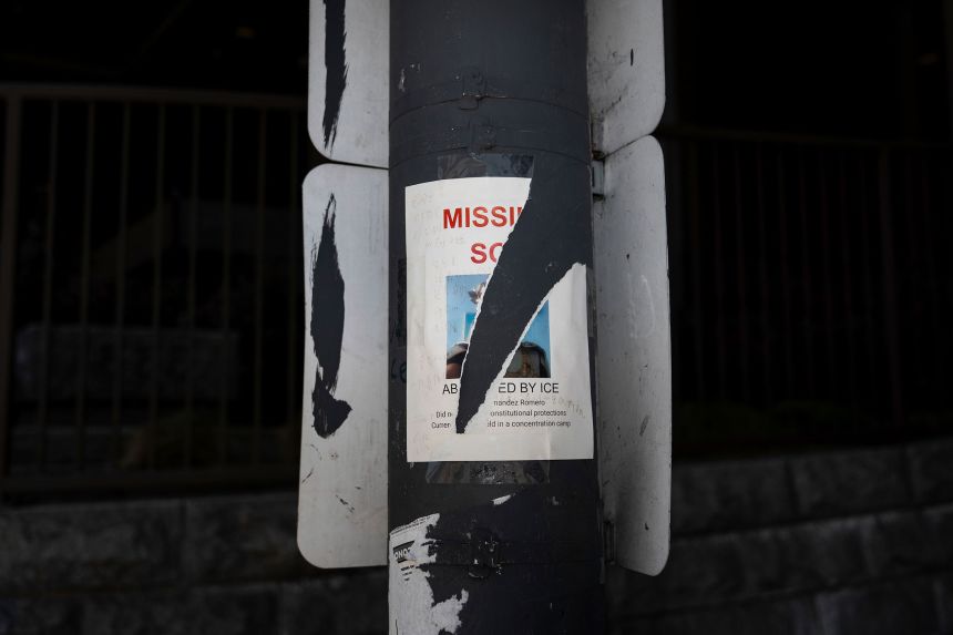 A torn missing person poster for an immigrant believed to be detained by ICE is posted on a pole in Los Angeles on July 19
