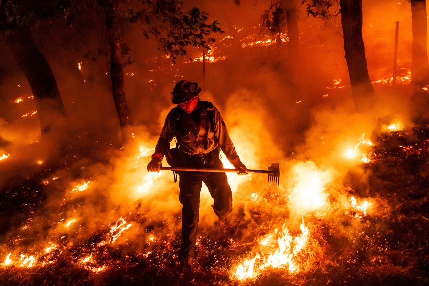 A firefighter battles the Pickett Fire burning in Napa County, California, on Saturday.