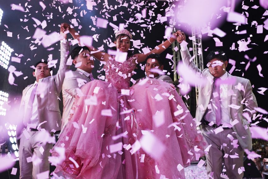 Confetti falls over Isela Santiago Morales, organized by the community at her 15th birthday party at the stadium in Astra de Terrazas, Mexico on Saturday, August 23, 2025, after her father's social media charm sparked support following her first attendance celebration.