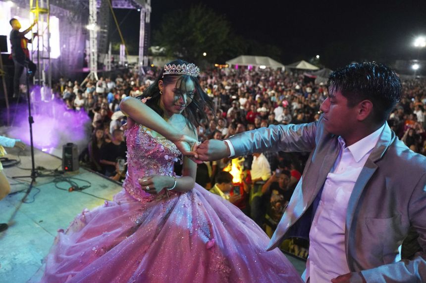 Isela Anali Santiago Morales dances during her 15th birthday party at a stadium in Axtla de Terrazas, Mexico, Saturday, Aug. 23, 2025, organized by the community after her father's social media appeal drew support following her first sparsely attended party.