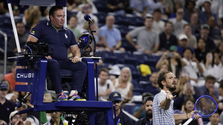 Daniil Medvedev, of Russia, bottom right, reacts next to chair umpire, Greg Allensworth, left, after a photographer ran onto the court during a match against Benjamin Bonzi, of France, in the first-round of the U.S. Open tennis championships in New York City, August  24, 2025.