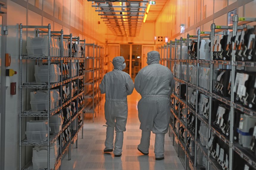 Employees of Nexperia walk through the semiconductor manufacturer's clean rooms in Hamburg, Germany.