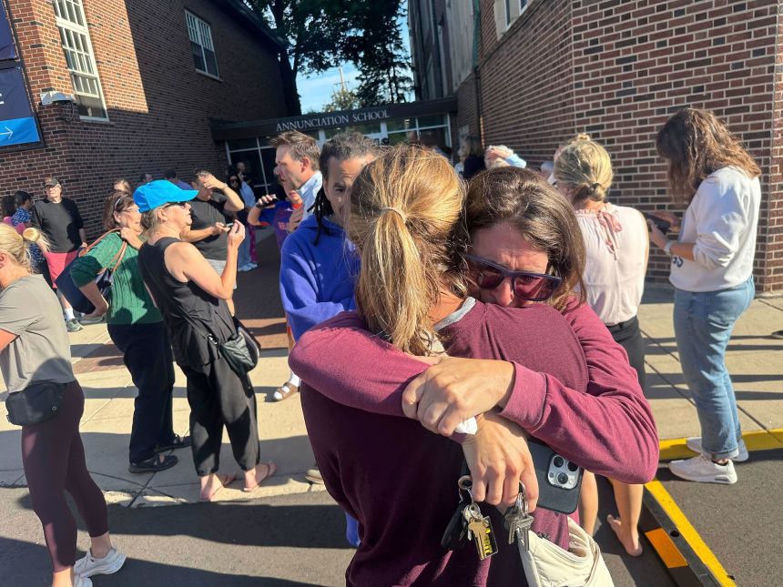 Parents await news of their children after a reported shooting at Annunciation Church on Wednesday in Minneapolis.