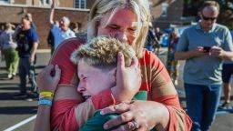 A parent hugs her son during an active shooter situation at the Annunciation Church in Minneapolis, Minn., Wednesday, Aug. 27, 2025. (Richard Tsong-Taatarii/Star Tribune via AP)