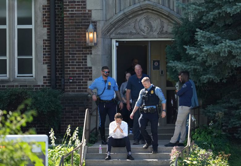 Minneapolis Mayor Jacob Frey sits on the steps of the Annunciation Church's school after the shooting Wednesday morning.