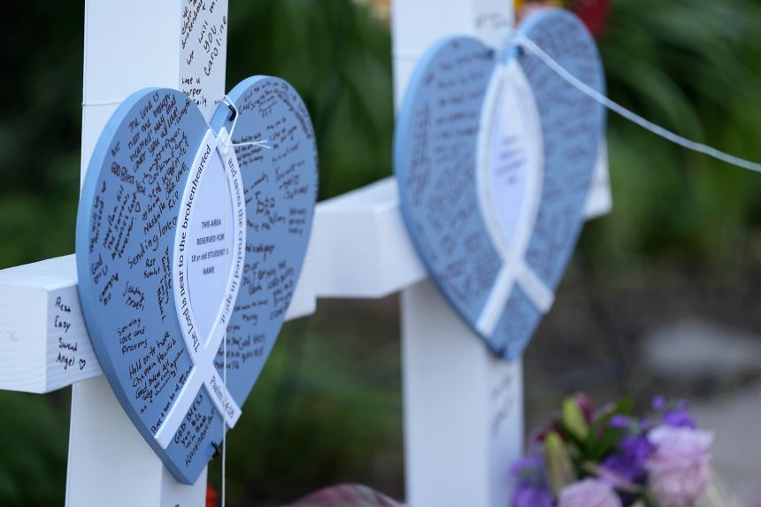 Written messages are left on hearts at a makeshift memorial at Annunciation Catholic Church and School in Minneapolis on Thursday.