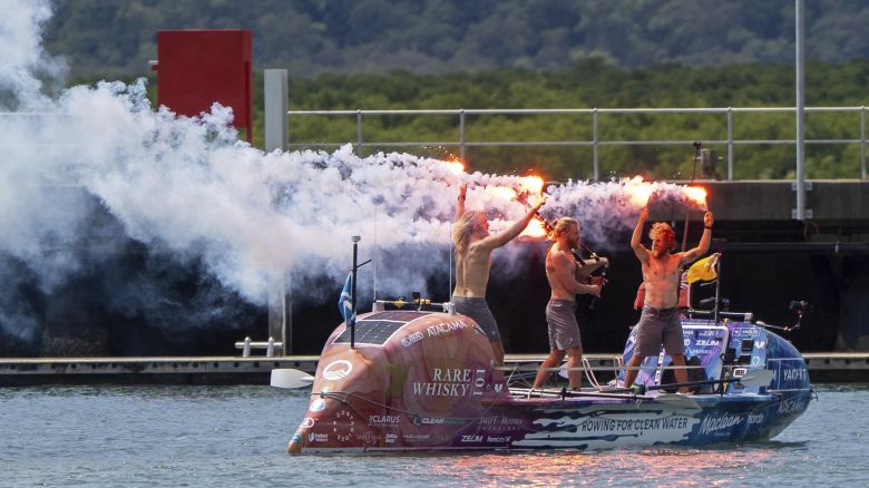 Scottish brothers, Ewan, Jamie and Lachlan, Maclean react after completing their record breaking row from Peru across the Pacific Ocean to Cairns, Australia, Saturday, Aug. 30, 2025.