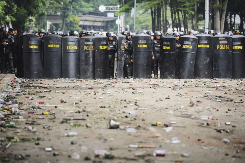 Debris litters the street following violent protests in the Indonesian capital.