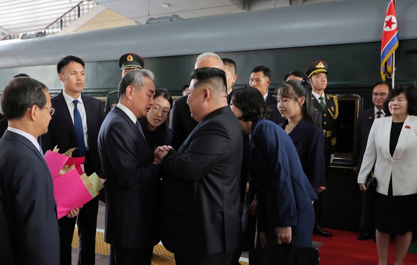 A girl believed to be Kim Jong Un's daughter stands behind the North Korean leader in this photo provided by the North Korean government, Tuesday, Sept. 2, 2025.