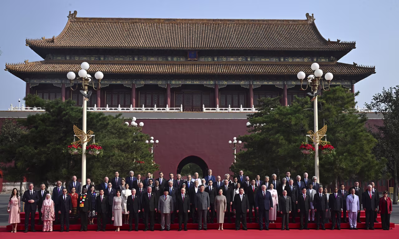 Chinese President Xi Jinping with his wife Peng Liyuan, center, pose for a family photo with a selection of world leaders before a military parade in Tiananmen Square in Beijing, China, on Wednesday.