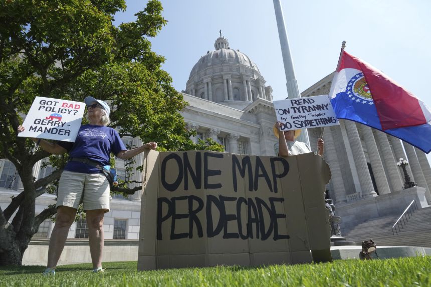 Robin Rothove, left, and Paula Smith, right, demonstrate outside the Missouri Capitol as lawmakers prepare to conduct a committee hearing inside to consider redrawing the state's US House districts on September 4, in Jefferson City, Missouri.