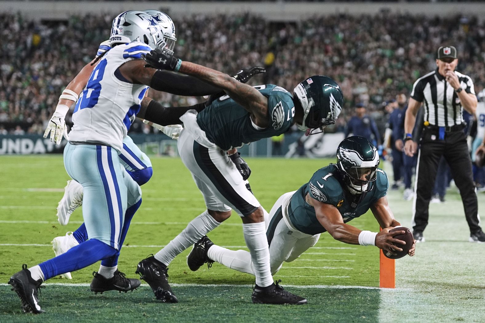 Philadelphia Eagles quarterback Jalen Hurts dives into the end zone to score a touchdown in the first half of the <a href="index.php?page=&url=https%3A%2F%2Fwww.cnn.com%2Fsport%2Flive-news%2Fus-open-semifinals-cowboys-eagles-nfl-09-04-25%23cmf6b6phy0034356nv6nszrlx">NFL's season-opening game</a> on Thursday, September 4. Hurts ran for two touchdowns as the Eagles, the defending Super Bowl champions, defeated the Dallas Cowboys 24-20.
