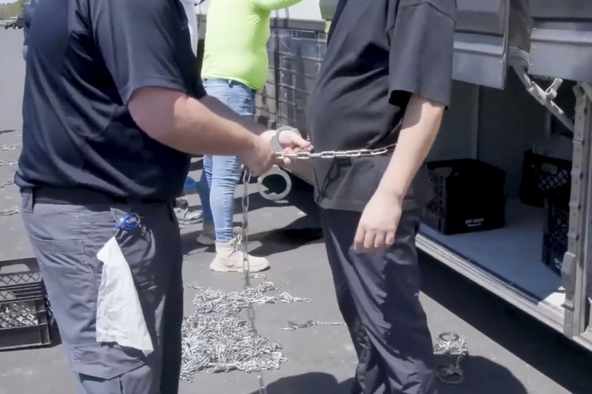This image from video provided by US Immigration and Customs Enforcement shows a person being handcuffed at the Hyundai Motor Group’s electric vehicle plant, in Ellabell, Georgia, on Thursday.