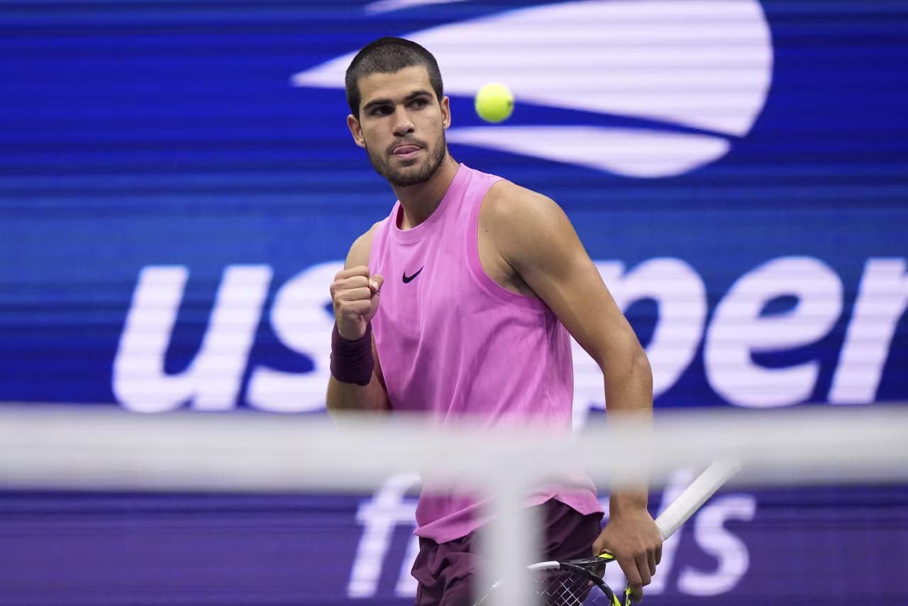 Carlos Alcaraz celebrates a point in the fourth set.