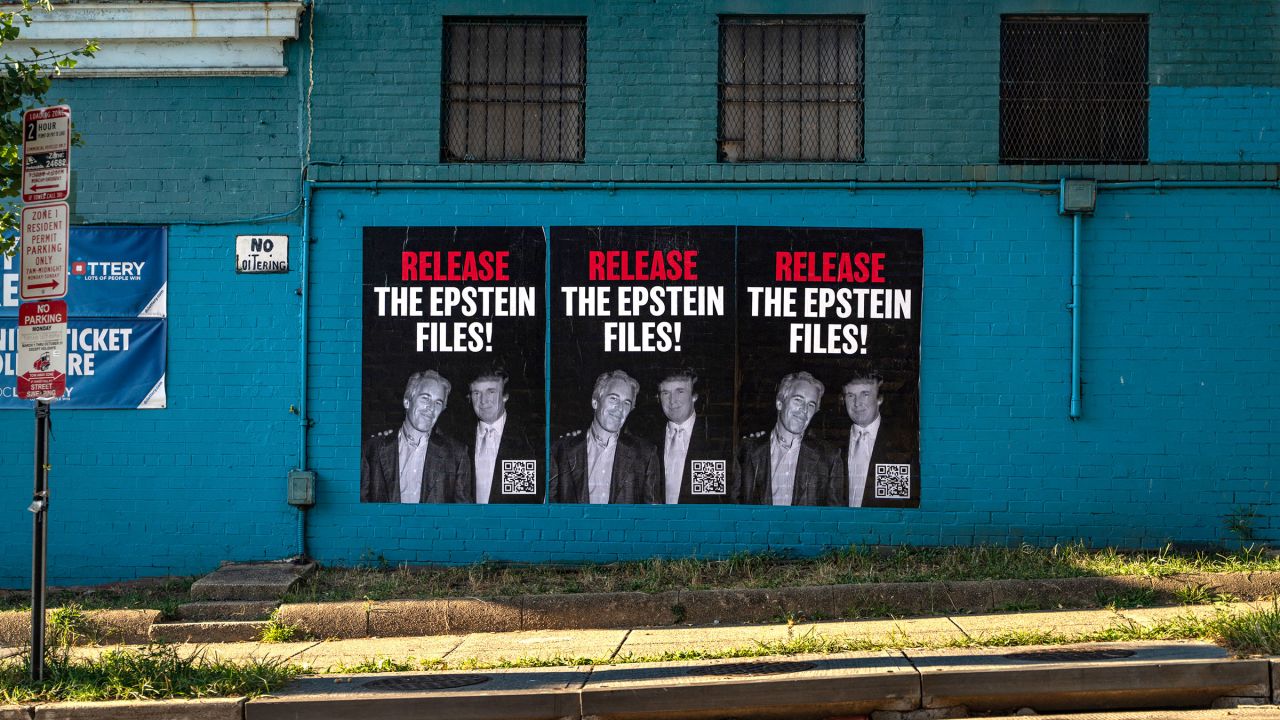 Three 'RELEASE THE EPSTEIN FILES' posters, depicting President Trump and Jeffrey Epstein together, are seen pasted on the outside of a liquor store in Washington, DC on September 8, 2025. (Photo by Emily Alff/Sipa USA)(Sipa via AP Images)