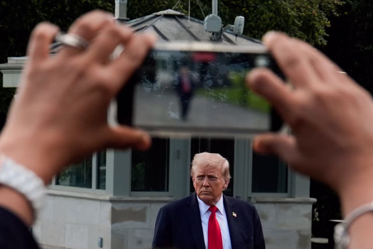 President Donald Trump walks to speak with reporters on the South Lawn of the White House in September.