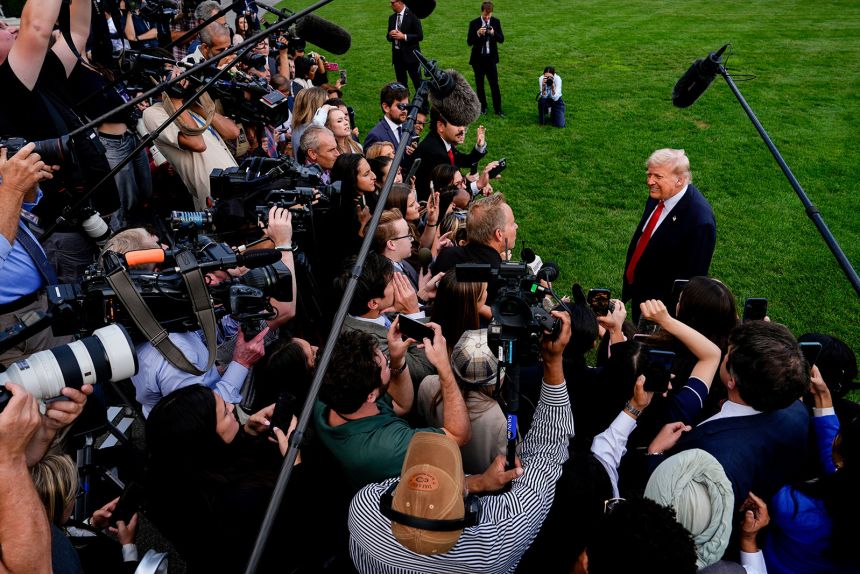 US President Donald Trump speaks with reporters on the South Lawn as he departs the White House on Thursday.