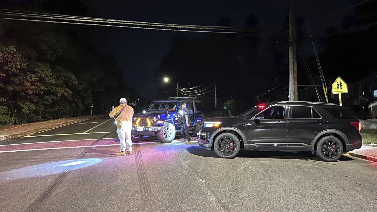 Police block a road to a country club where a shooting happened at Sky Meadow Country Club in Nashua, New Hampshire, Saturday, September 20, 2025.