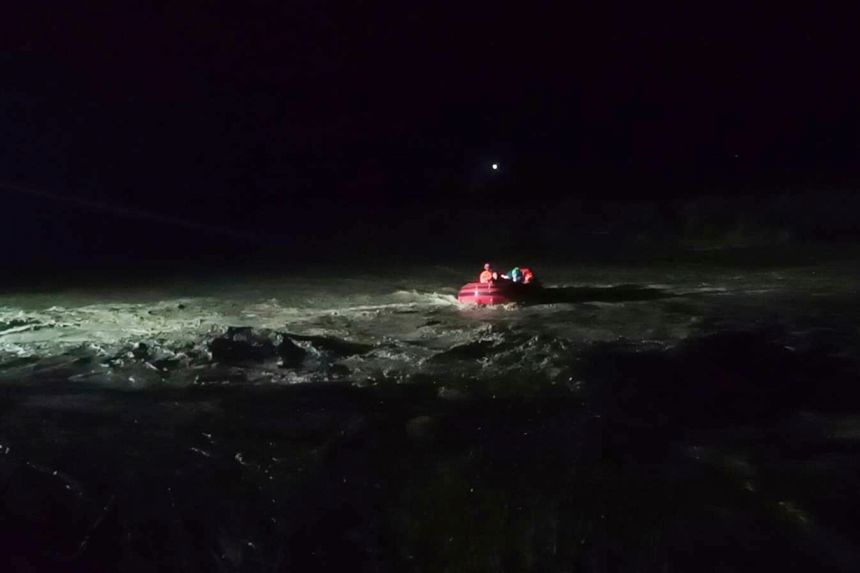 Rescuers help evacuate residents along a swollen river as Super Typhoon Ragasa affects Salcedo, Ilocos Sur province, northern Philippines, on September 22, 2025.