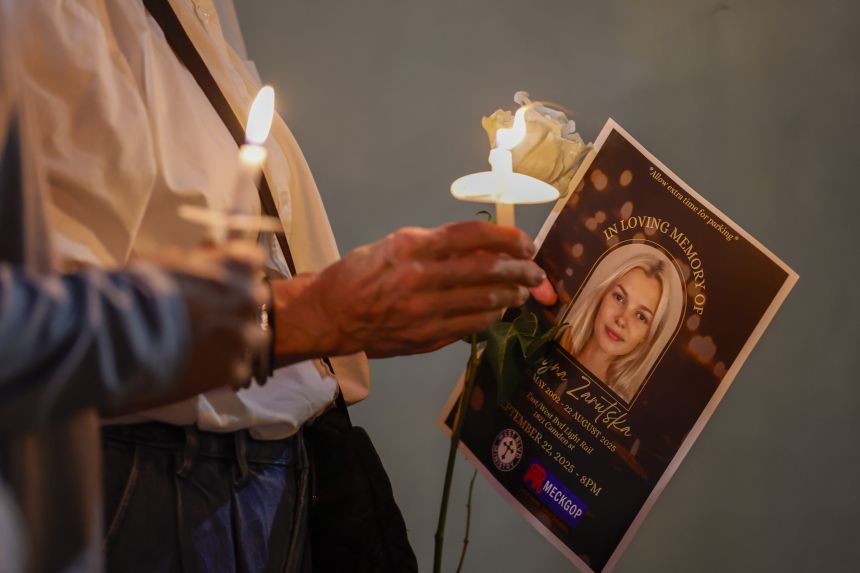 Community members hold candles as they gather for a vigil honoring the life of Iryna Zarutska, who was fatally stabbed on a commuter train in Charlotte, North Carolina.