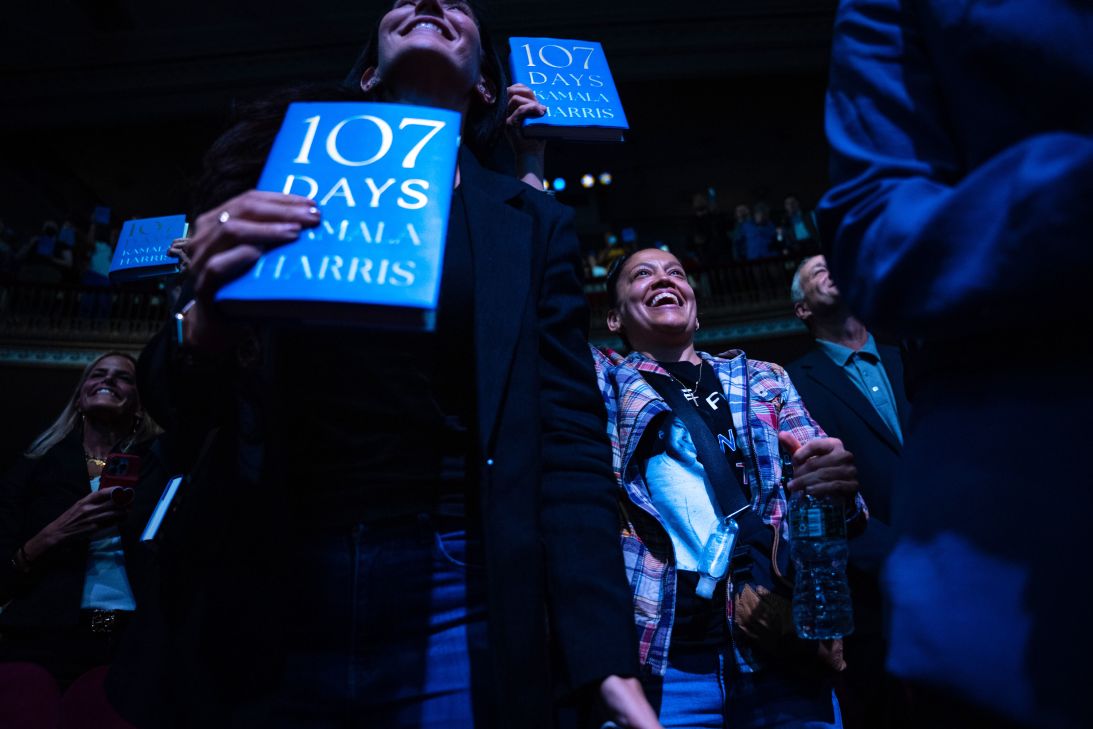 People display their copies of former Vice President Kamala Harris' new book 