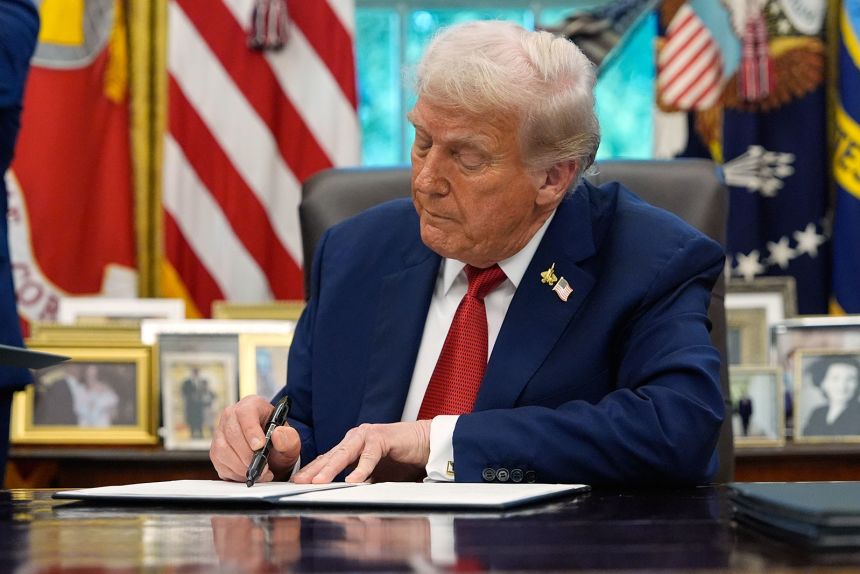 President Donald Trump signs a presidential memorandum on the death penalty in the District of Columbia in the Oval Office at the White House, on Thursday, September 25, in Washington, DC.