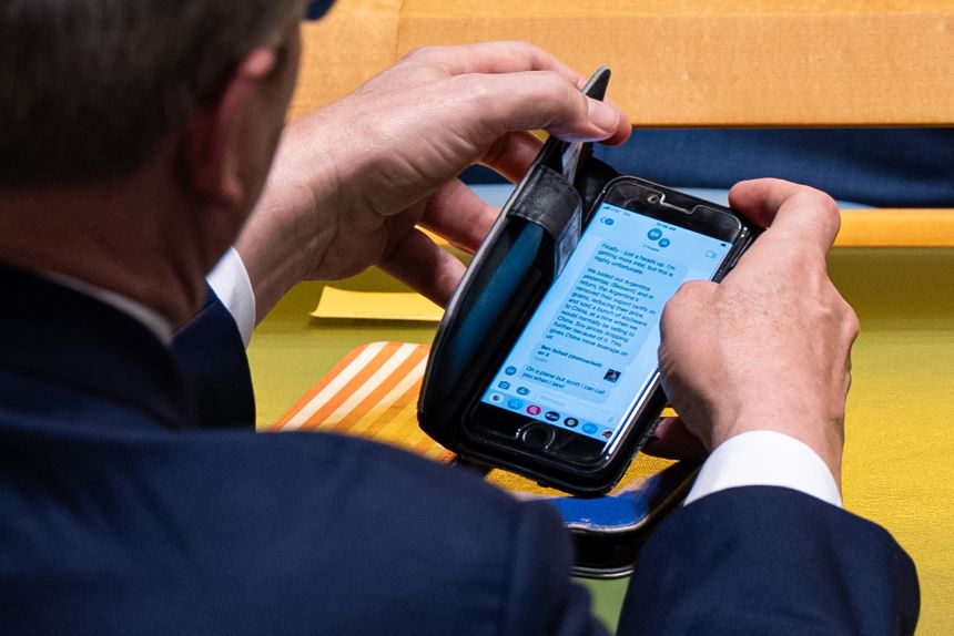 Treasury Secretary Scott Bessent checks a text message regarding Argentina relations with the United States during the 80th session of the United Nations General Assembly on September 23.