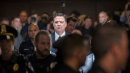 Former FBI director James Comey walks through a corridor on the way to a secure room to continue his testimony to the Senate Select Committee on Intelligence, on Capitol Hill in Washington, DC, on June 8, 2017.