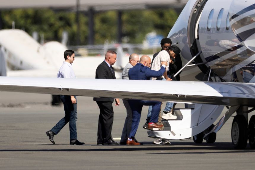 Harjinder Singh is escorted onto an airplane by Florida Lt. Gov. Jay Collins and law enforcement on Thursday, Aug. 21, 2025, in Stockton, California.