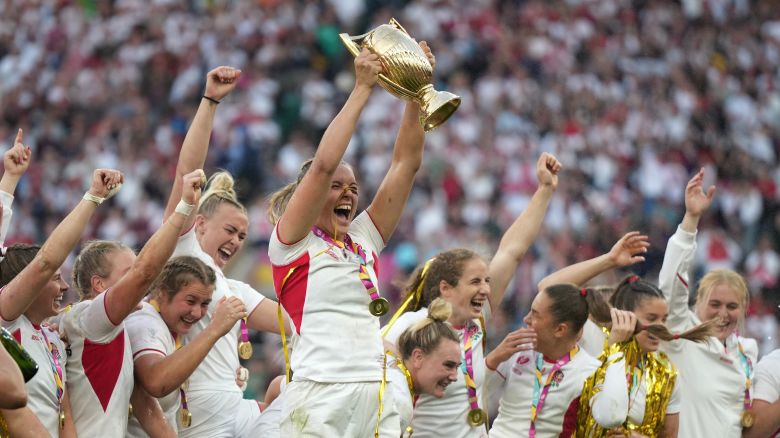 England's Zoe Aldcroft holds a trophy as she celebrates with her teammates after winning the Women's Rugby World Cup final match between England and Canada at the Allianz Stadium, Twickenham, London.