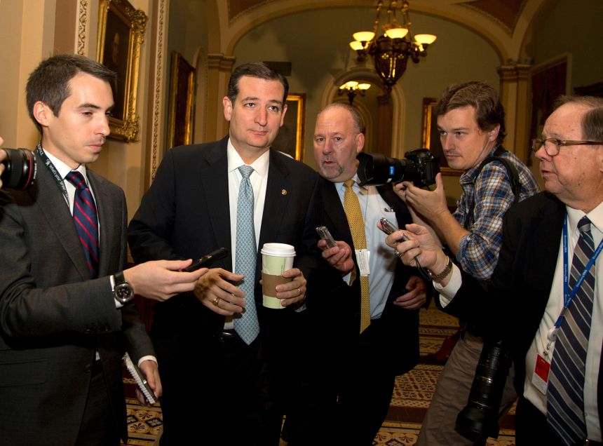 Sen. Ted Cruz is followed by reporters on Capitol Hill, on October 16, 2013, as time grew short for Congress to stop a partial government shutdown.