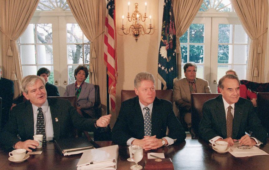 President Bill Clinton, center, meets with House Speaker Newt Gingrich, left, and Senate Majority Leader Bob Dole, to grapple with competing balanced budget plans, at the White House on December 31, 1995. The second government shutdown of Clinton’s presidency lasted 22 days.