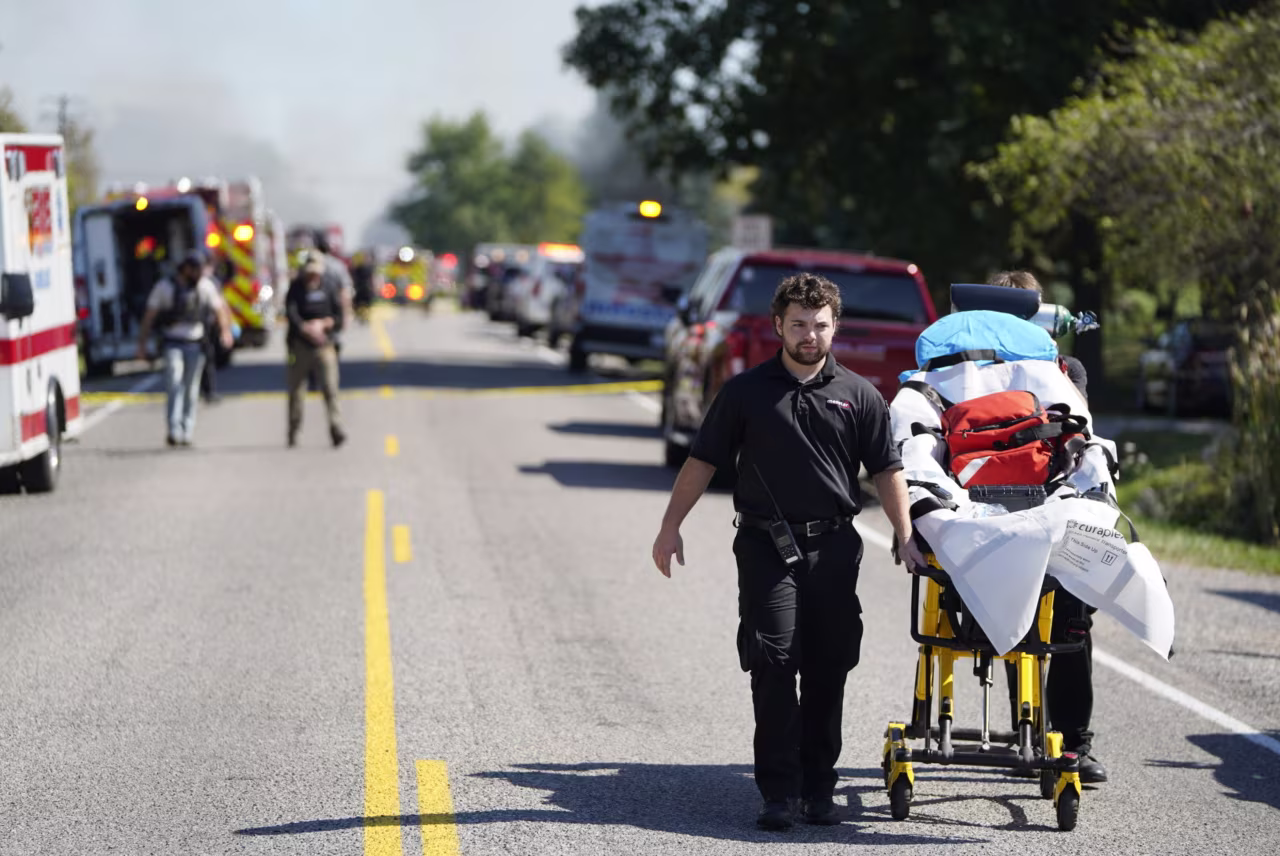 Emergency responders work outside of The Church of Jesus Christ of Latter-day Saints following a shooting and fire on Sunday.