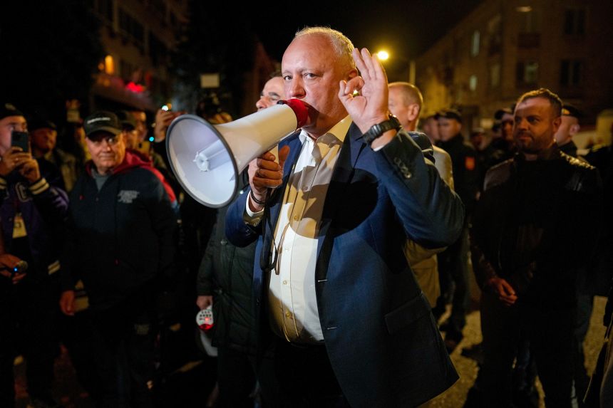 Former Moldovan President Igor Dodon, a member of the pro-Russian Patriotic Electoral Bloc, speaks to supporters protesting outside the Electoral Commission after the polls closed on Sunday.