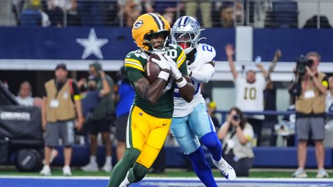 Green Bay Packers wide receiver Romeo Doubs (87) catches a touchdown pass as Dallas Cowboys cornerback Kaiir Elam (20) defends in the second half of an NFL football game in Arlington, Texas on September 28, 2025.