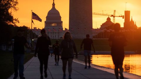 People walk along the National Mall in Washington, DC, on October 1, 2025.
