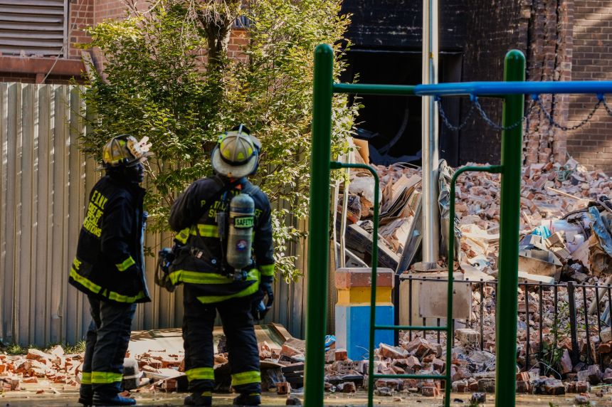 Firefighters work near the site of a partial building collapse in the Bronx borough of New York City.