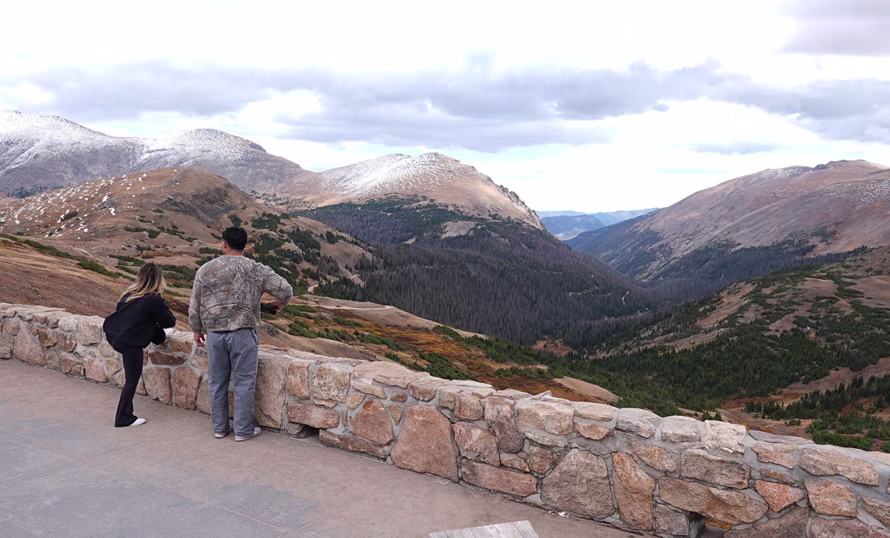 Visitors take in the view outside the locked Trail Ridge Road visitors center in Rocky Mountain National Park, which is closed because of the shutdown of the federal government on Wednesday, in Estes Park, Colorado.
