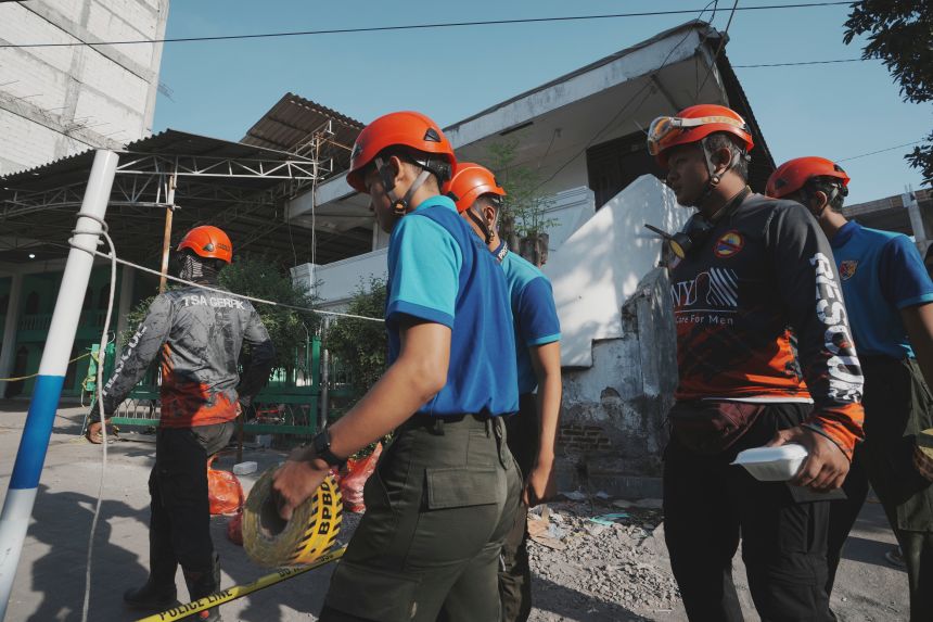 Rescuers walk to the site of the collapsed school in Sidoarjo, East Java, Indonesia, on October 2, 2025.