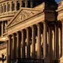 The Capitol is illuminated at sunrise to begin day three of a government shutdown, in Washington, Friday, Oct. 3, 2025. (AP Photo/J. Scott Applewhite)