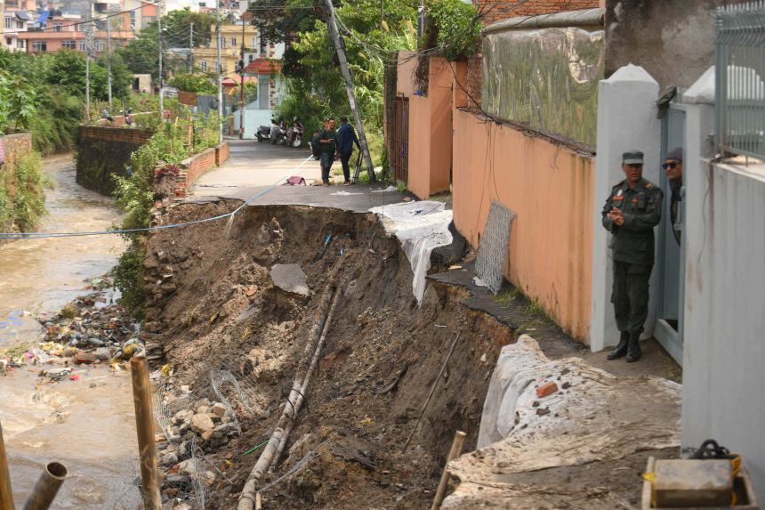 Kathmandu Metropolitan City Police reconstruct and clear debris from the Bafal riverside road in Kathmandu, Nepal, yesterday.