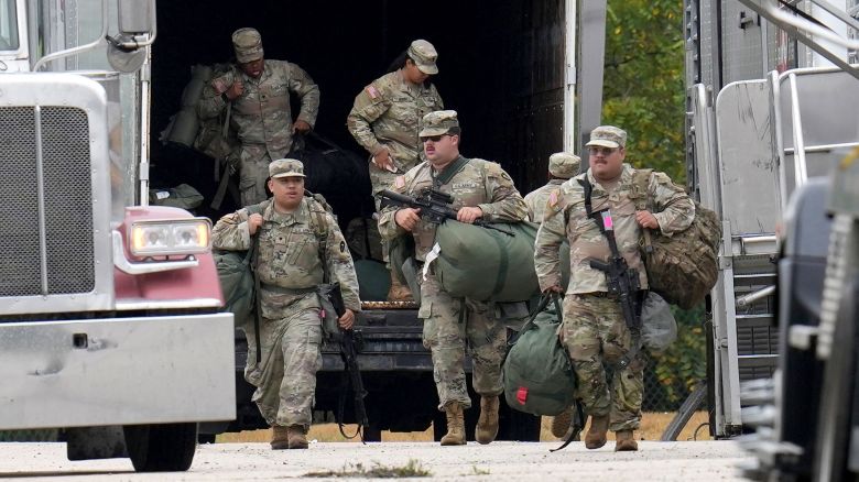 Military personnel in uniforms with the Texas National Guard patch are seen at the US Army Reserve Center in Elwood, Illinois, on Tuesday.