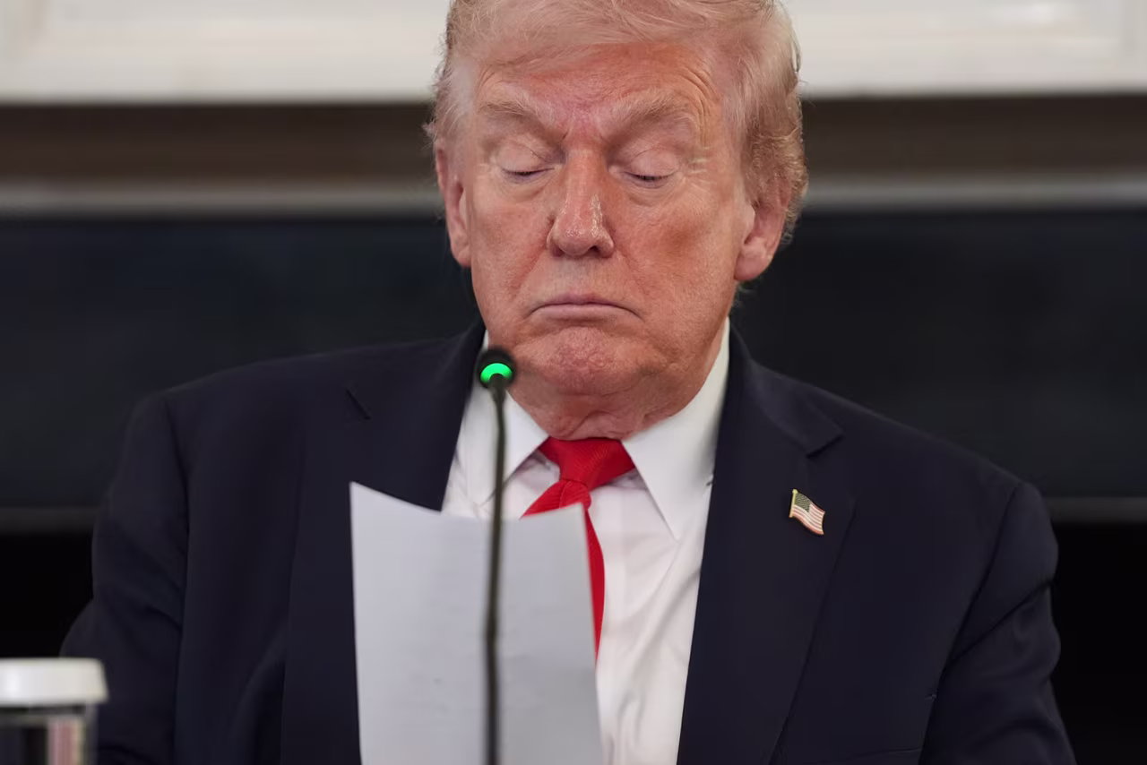 President Donald Trump reads a note handed to him by Secretary of State Marco Rubio at the White House on Wednesday.
